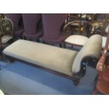 A Victorian mahogany chaise longue having carved scroll decoration and turned feet, 28 1/2"h x 70