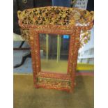 A 19th/20th century Chinese red lacquered table top mirror, carved and pierced with birds, flowers