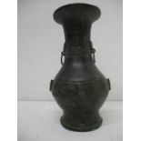 A 19th century Chinese bronze vase of bulbous form with a flared neck and foot decorated with