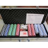 A cased set of poker chips in a metallic case