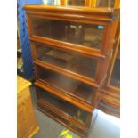 An early 20th century globe wernicke walnut bookcase having four glazed doors above a single drawer,