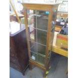 An early 20th century oak glazed cabinet having single door and square shaped feet, 60" h x 18 1/4"w