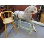 A dapple grey rocking horse A/F, together with a mid 20th century elm child's high chair
