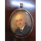 An Edwardian oval miniature of an aged gentleman wearing spectacles, unsigned