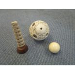 A cased ivory Chinese puzzle ball, a Victorian billiard ball and an Indian graduated elephant tree