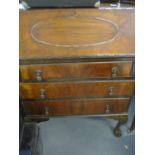 Early 20th century walnut bureau, fall flap revealing a fitted pigeonhole interior, above one