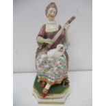 An early 19th century Bloor Derby figure of a woman sitting on a chair with books underneath,