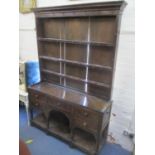 A late 18th/ early 19th century oak dresser having a plate rack above five drawers, 75" h x 51 1/2"