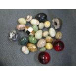 A collection of stone and onyx eggs and crystal geode