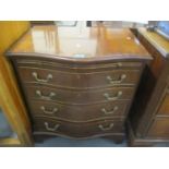 A reproduction Georgian style, serpentine fronted gentleman's dressing chest with brushing slide,
