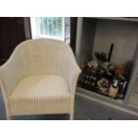 A white painted Lloyd Loom armchair and a quantity of ornaments to include a model of a shire