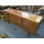 A mid 20th century retro teak sideboard having three drawers flanked by two cupboards, 29 1/2"h x 67
