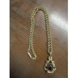 A 19th century metal pendant set with a cabochon garnet, on a 9ct gold chain link necklace, total
