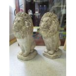 A pair of weathered concrete garden lions, 19 1/2" h