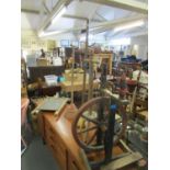 Three wooden washing dollies, two wash boards and a spinning wheel