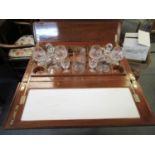 An Edwardian inlaid mahogany rising topped drinks cabinet, with a twin flap top containing glassware