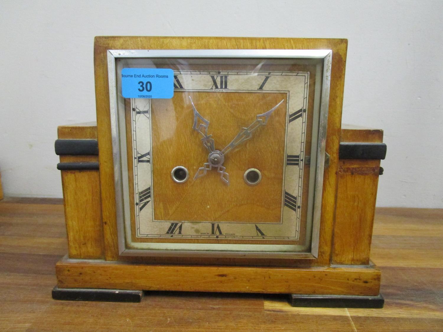 A 1930s Enfield walnut cased with ebonized highlights, 8 day mantle clock, striking on a gong,