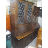 A mid 20th century oak linenfold display cabinet, together with an early 20th century walnut cabinet