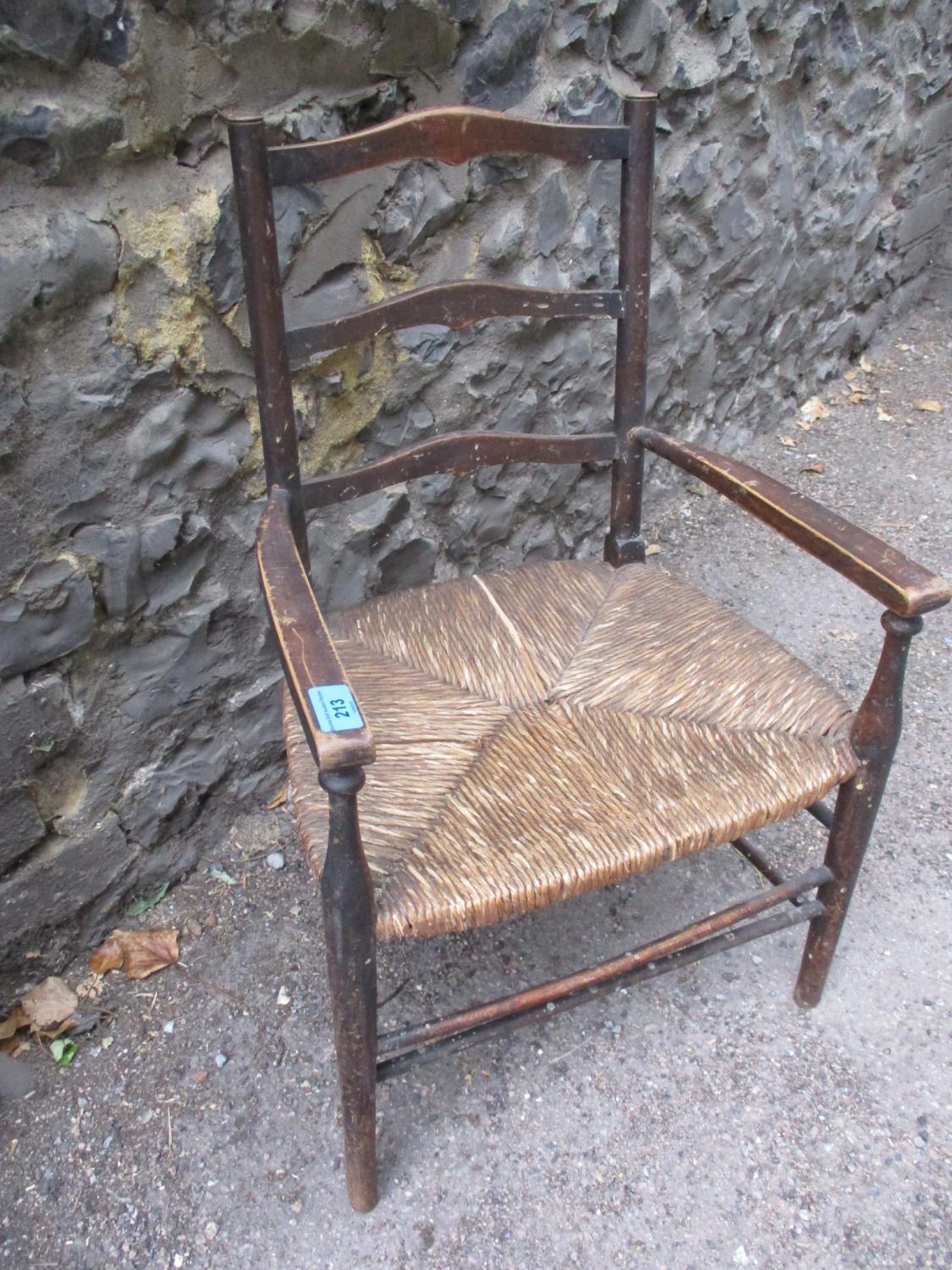 An early 20th century rush seated child's chair and christening gown - Image 2 of 2