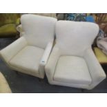 A pair of modern grey upholstered armchairs, standing on beech feet