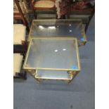 Two conservatory gilt metal and glass topped tables and two metal travelling trunks, one bearing the