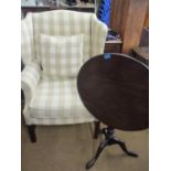 A modern mahogany framed wingback armchair in a cream and beige gingham checked fabric together with