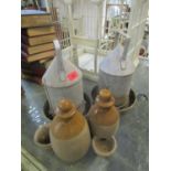 Two galvanized steel bird feeders and two stoneware chicken drink/feeders