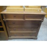 A 20th century French oak chest of two short and three long drawers standing on bracket shaped
