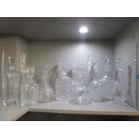 A group of fourteen cut glass, engraved and acid decorated Victorian and later decanters to