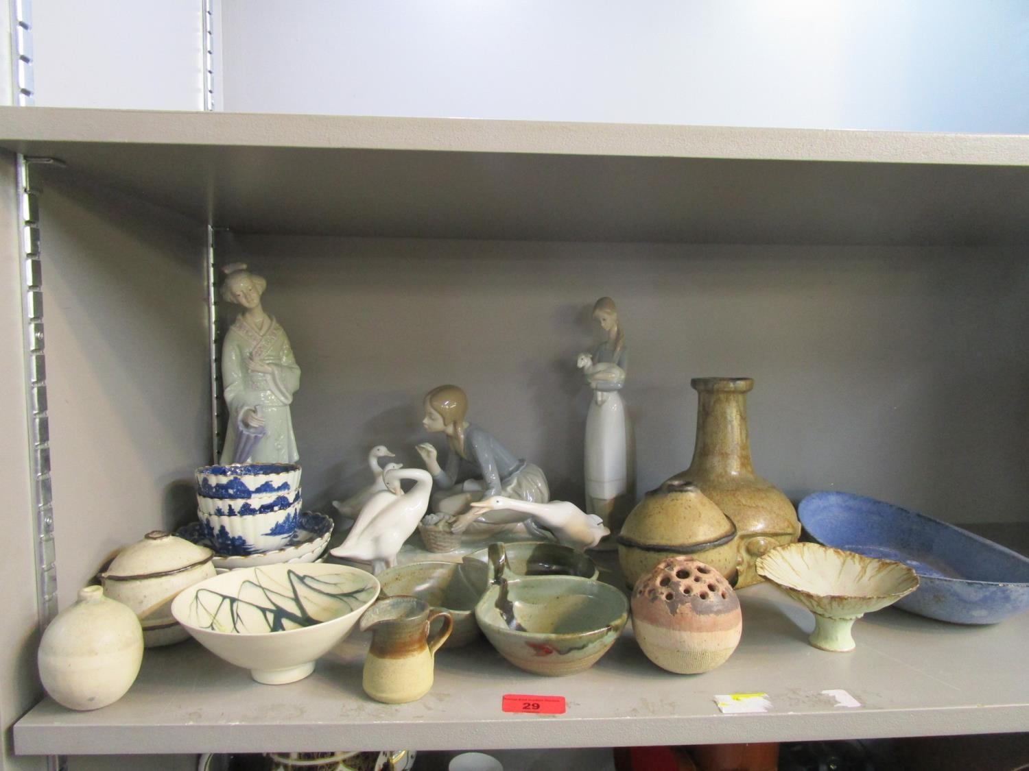 A group of Lladro porcelain figures, Caughey blue and white tea bowls and a selection of studio