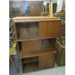 A set of three retro teak effect wall cupboards with sliding doors