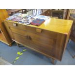 A mid 20th century Minty retro sideboard having two drawers above two cupboard doors and standing on