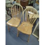 A pair of light elm seated Windsor stick back chairs