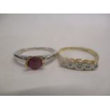 An 18ct gold and diamond ring and a 9ct white gold ring set with a ruby