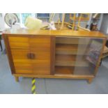 A mid 20th century Minty bookcase/cabinet, glass sliding doors and twin cupboard doors, standing
