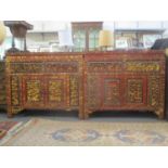 A near pair of 19th/20th century Chinese red lacquered cabinets with profusely carved ornament, with