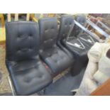 A set of six modern black imitation leather upholstered chairs on cantilever legs