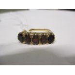 A 9ct gold and five garnet ring. TotaL weight 5.1g. Ring size 'O'