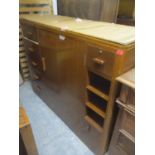 A mid 20th century walnut finished large cabinet having one large central door flanked by drawers