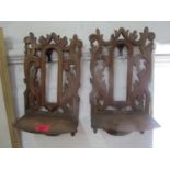 A pair of carved wooden wall brackets