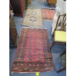 A group of three hand woven middle eastern rugs