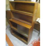 A mid 20th century Minty teak four tier bookcase having glass sliding doors, 59" h x 36"w