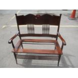 An early 20th century mahogany American two seater armchair