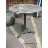 A modern cast iron and marble topped garden table and a garden umbrella stand