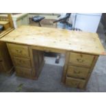 A Victorian pine twin pedestal desk having one long central drawer flanked by six drawers 31"h x