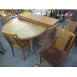 A mid 20th century teak extending dining table with three extra leaves, 28 3/4"h x 94 1/4"w when