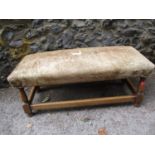 An oak framed double foot stool with cow hide upholstery, A/F