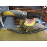 An Asian hardwood painted child's rocker in the form of an exotic bird, A/F