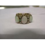 A 9ct gold and opal ring having three large opals and six small opals. Total weight 6.0g. Ring