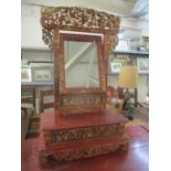 A 19th/20th century Chinese red lacquered table top mirror, carved and pierced with birds, flowers